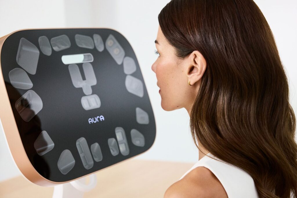 Woman facing the Aura Reality face scanner