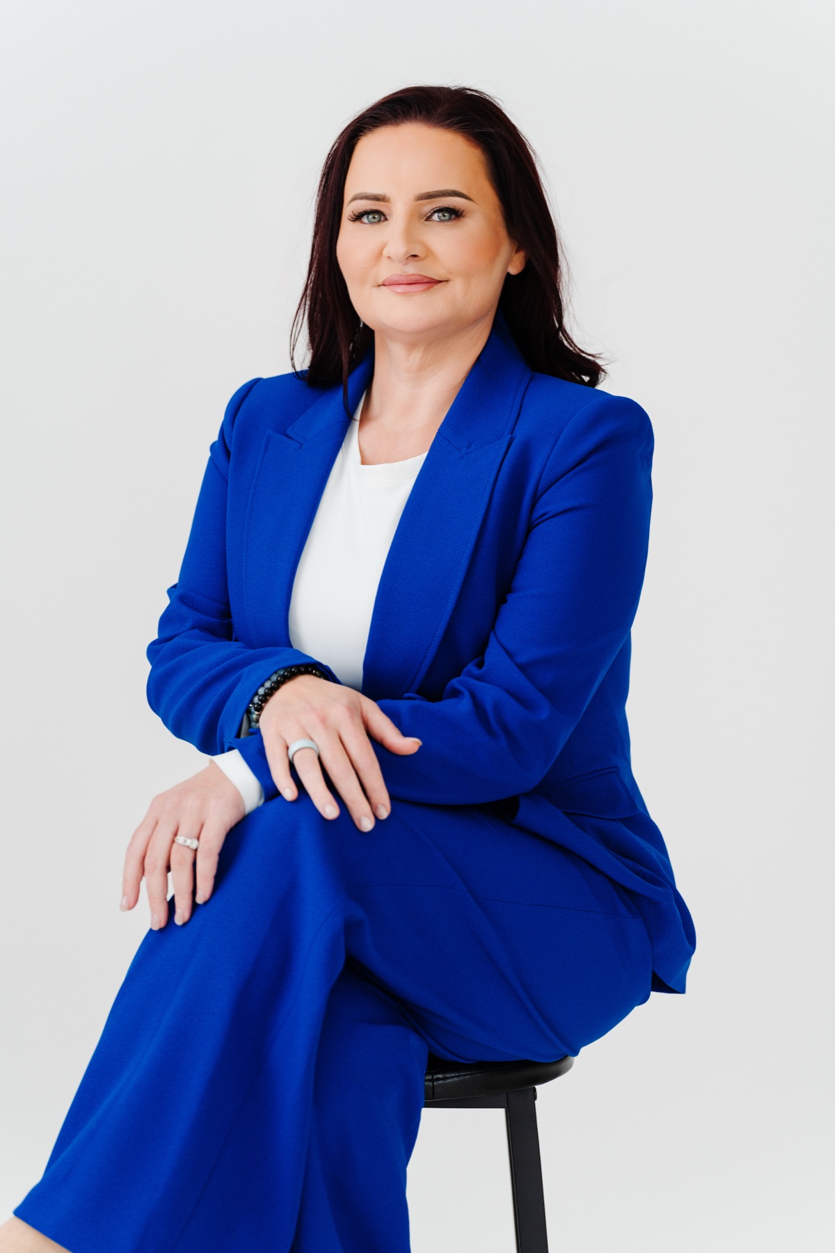 Sarah Sanchez seated in a blue suit