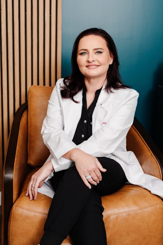 Sarah Sanchez, FNP-C, in her white coat in the clinic