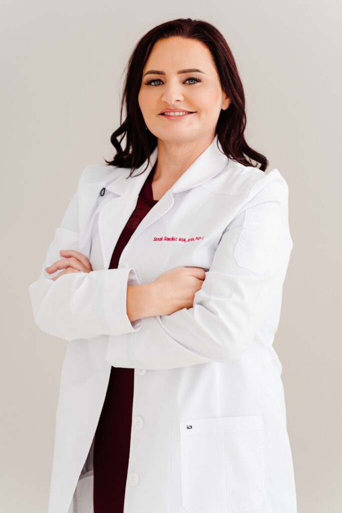 Sarah Sanchez, FNP-C, nurse practitioner, in a white coat