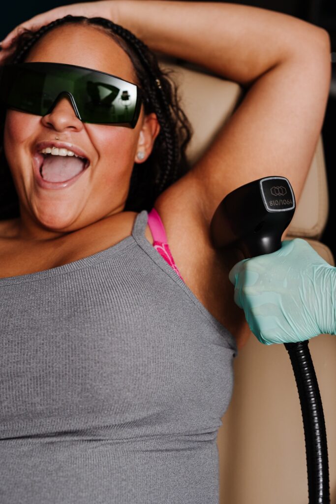Patient smiling during underarm laser hair removal